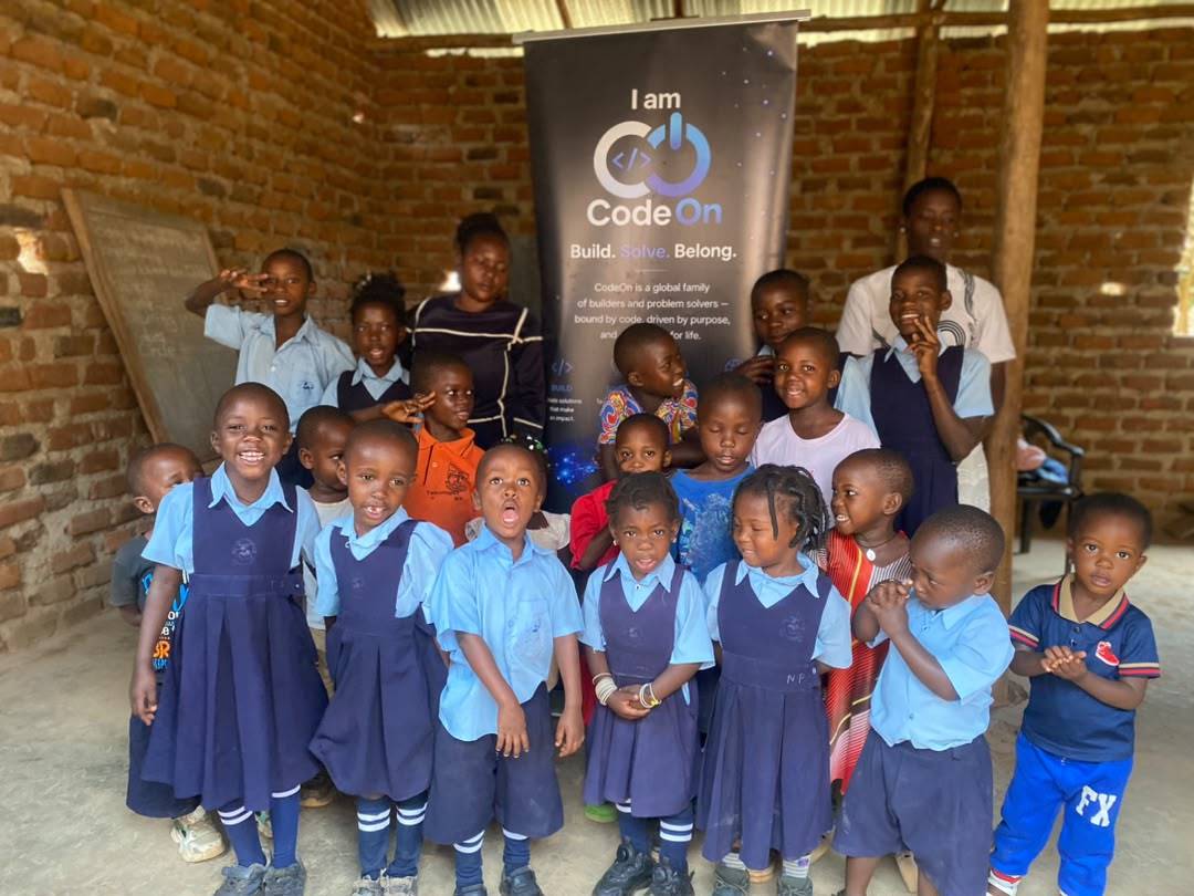 A full classroom of students with the CodeOn banner